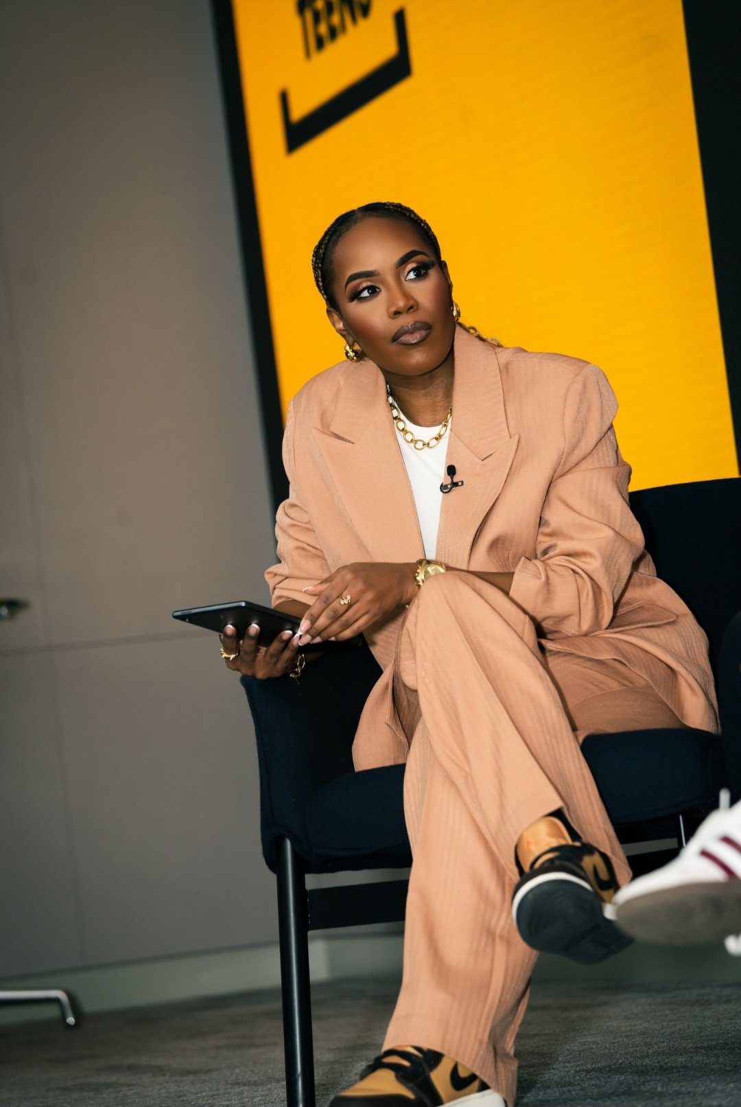 Charlene Gravesande speaking with a microphone